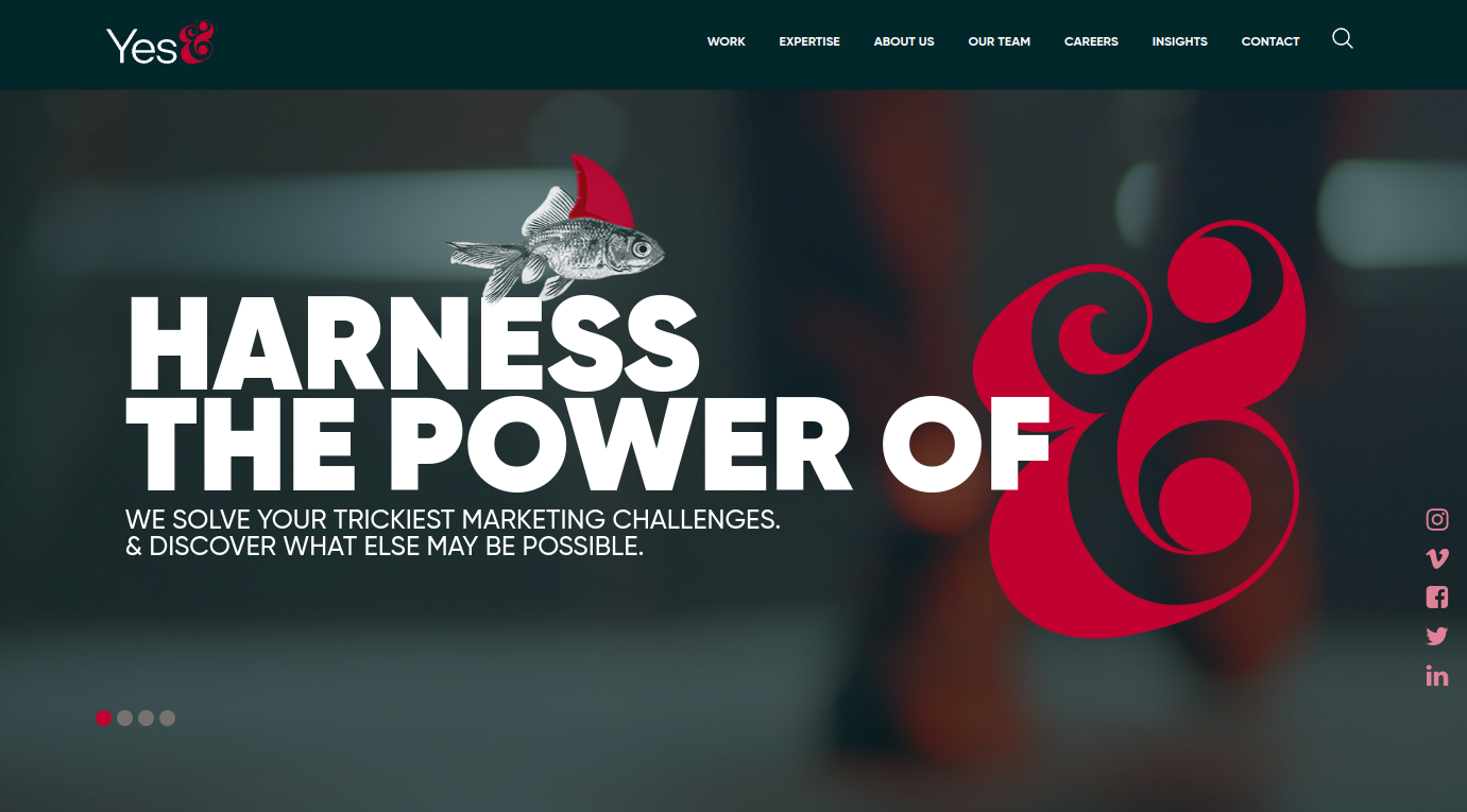```json
{
"alt": "Marketing agency homepage with a fish wearing a shark fin and the text 'Harness the Power of &'.",
"caption": "Unleash creativity with Yes&, where even a fish can be a shark! Dive into innovative marketing solutions with the power of ‘&’.",
"description": "The homepage of Yes& marketing agency highlights a creative image of a fish wearing a shark fin, symbolizing transformation and potential. The bold text reads 'Harness the Power of &' alongside the agency's logo. This design emphasizes their expertise in tackling complex marketing challenges. The image is accompanied by a menu bar with options like Work, Expertise, About Us, and social media icons, enhancing user interaction and navigation."
}
```