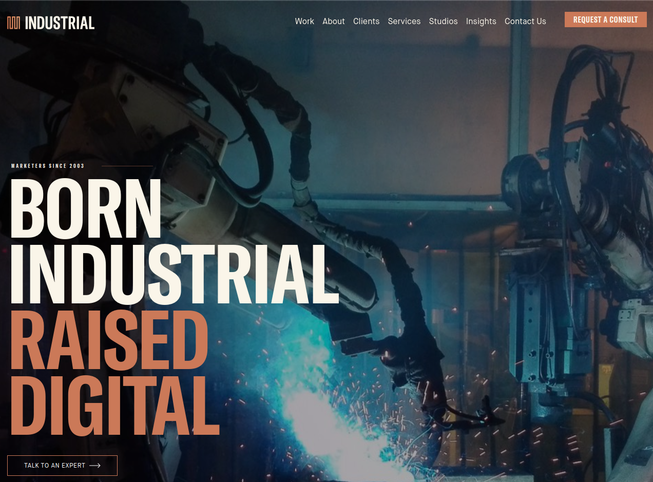```json
{
  "alt": "Robotic arm with sparks in an industrial setting; text reads: Born Industrial, Raised Digital.",
  "caption": "A robotic arm glows with sparks, symbolizing the fusion of traditional industry and digital innovation. Born Industrial, Raised Digital.",
  "description": "This image features a robotic arm in an industrial environment, emitting sparks indicative of active machinery. Overlaying the image is bold text that states 'Born Industrial, Raised Digital,' representing the integration of traditional industrial methods with modern digital technologies. The setting is a factory-like backdrop, hinting at modern manufacturing processes. Key elements are the robotic arm, sparks, and the prominent overlay text."
}
```