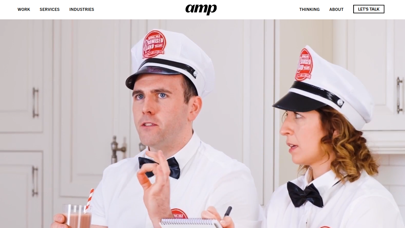 ```json
{
  "alt": "Two people wearing white uniforms and hats in a kitchen setting, one holding a notepad.",
  "caption": "Dressed in classic diner uniforms, these two are ready for action with a notepad and a refreshing drink in hand.",
  "description": "The image features two individuals in white uniforms and hats, reminiscent of vintage diner staff, in a bright kitchen. The person on the left holds a glass with a striped straw and gestures animatedly, while the person on the right listens attentively with a notepad. The scene evokes a sense of nostalgia and teamwork, capturing a moment of lively discussion."
}
```
