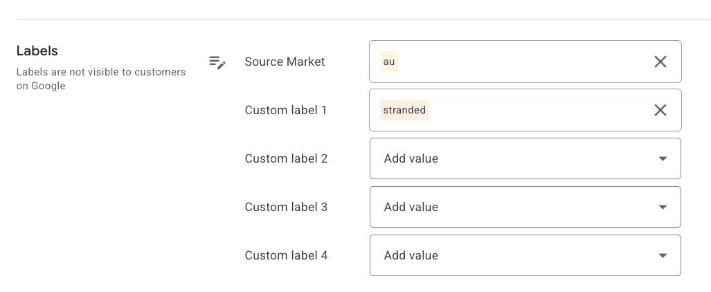 ```json
{
"alt": "Interface showing Google Ads labels with 'Source Market' and 'Custom labels'.",
"caption": "A glimpse into organizing data with Google Ads labels—where Source Market and Custom labels streamline categorization.",
"description": "The image displays the 'Labels' section of Google's interface, featuring 'Source Market' with a label 'au' and 'Custom label 1' marked 'stranded'. Other custom labels are yet to be filled, providing a flexible setup for organizing and filtering data within Google Ads. These labels assist in categorizing and managing marketing campaigns more effectively."
}
```