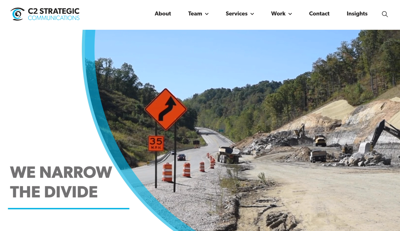 ```json
{
  "alt": "Road construction scene with warning signs and construction vehicles on a sunny day.",
  "caption": "Navigating Progress: An ongoing road construction project highlights careful planning and teamwork under a clear blue sky.",
  "description": "The image depicts a road construction site under a clear blue sky. A winding road warning sign and 35 M.P.H speed limit are visible. Construction vehicles work on a rocky terrain to the right. The surrounding landscape is lush and green, indicating a rural location. This scene exemplifies infrastructure development and effective communication strategies in action."
}
```