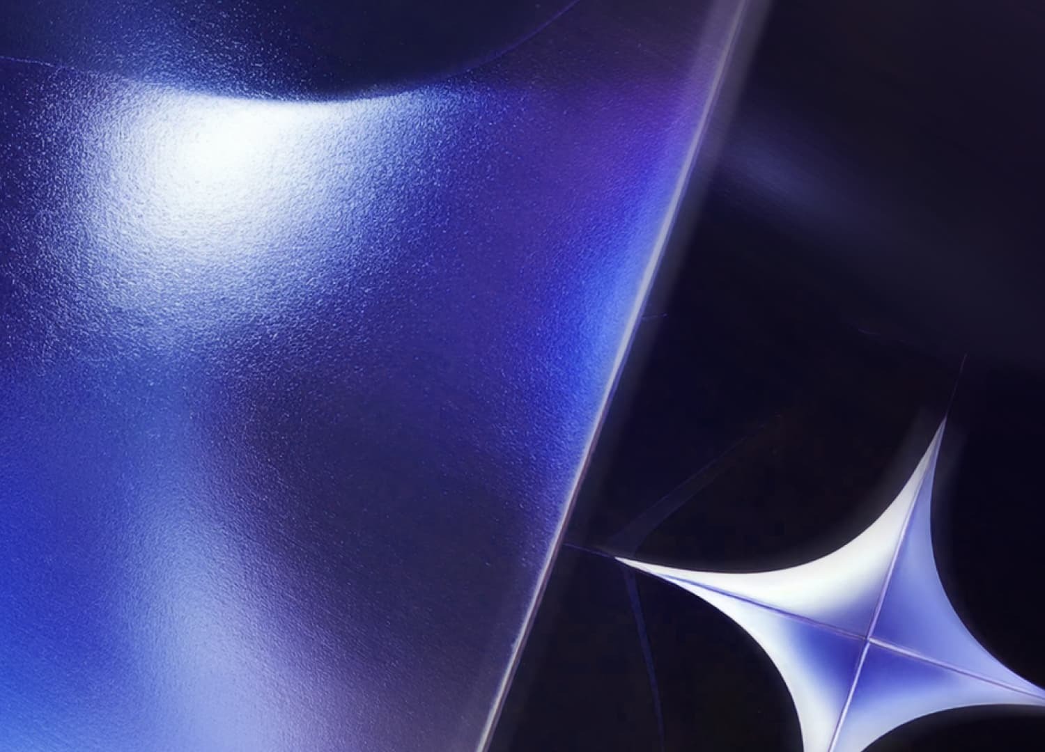```json
{
  "alt": "Abstract image with a metallic blue and purple surface and a cross-shaped light reflection.",
  "caption": "A mesmerizing play of light and color, this abstract image features a glossy blue surface beside a striking cross-shaped reflection.",
  "description": "This abstract image showcases a metallic surface with a gradient of blue and purple hues. The glossy texture catches the light, creating a smooth, reflective appearance. A cross-shaped light reflection adds a dynamic element to the composition. Perfect for modern art enthusiasts or digital backgrounds, this image highlights texture, light, and color interplay."
}
```