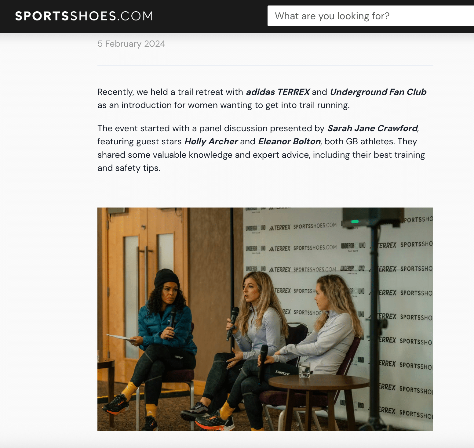 ```json
{
  "alt": "Three women seated on stage discussing trail running event with microphones.",
  "caption": "Trailblazing Talk: An engaging panel discussion on women's trail running tips and safety insights.",
  "description": "This image captures a panel discussion at a trail retreat organized by adidas TERREX and Underground Fan Club, featuring Sarah Jane Crawford alongside Holly Archer and Eleanor Bolton. The event, held on February 5, 2024, offered expert advice for women interested in trail running. The setting includes branded backdrops and audience engagement in a cozy indoor environment."
}
```