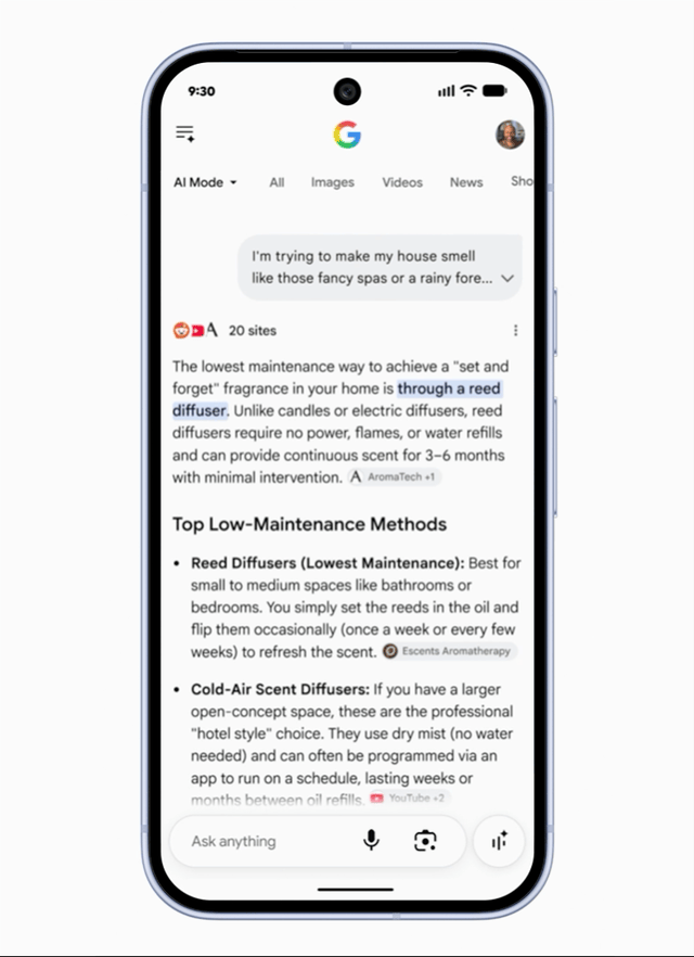 ```json
{
  "alt": "Smartphone screen showing Google AI mode with search results about reed diffusers.",
  "caption": "Exploring low-maintenance home fragrance options with Google AI, highlighting reed diffusers' benefits.",
  "description": "The image features a smartphone displaying Google AI mode, showing search results for home fragrance options. The highlighted text discusses the ease of using reed diffusers compared to other methods. The interface includes icons for browsing different media types like images, videos, and news. This visual represents modern tech-assisted conveniences for enhancing home environments. Keywords: smartphone, Google AI, reed diffuser, home fragrance."
}
```