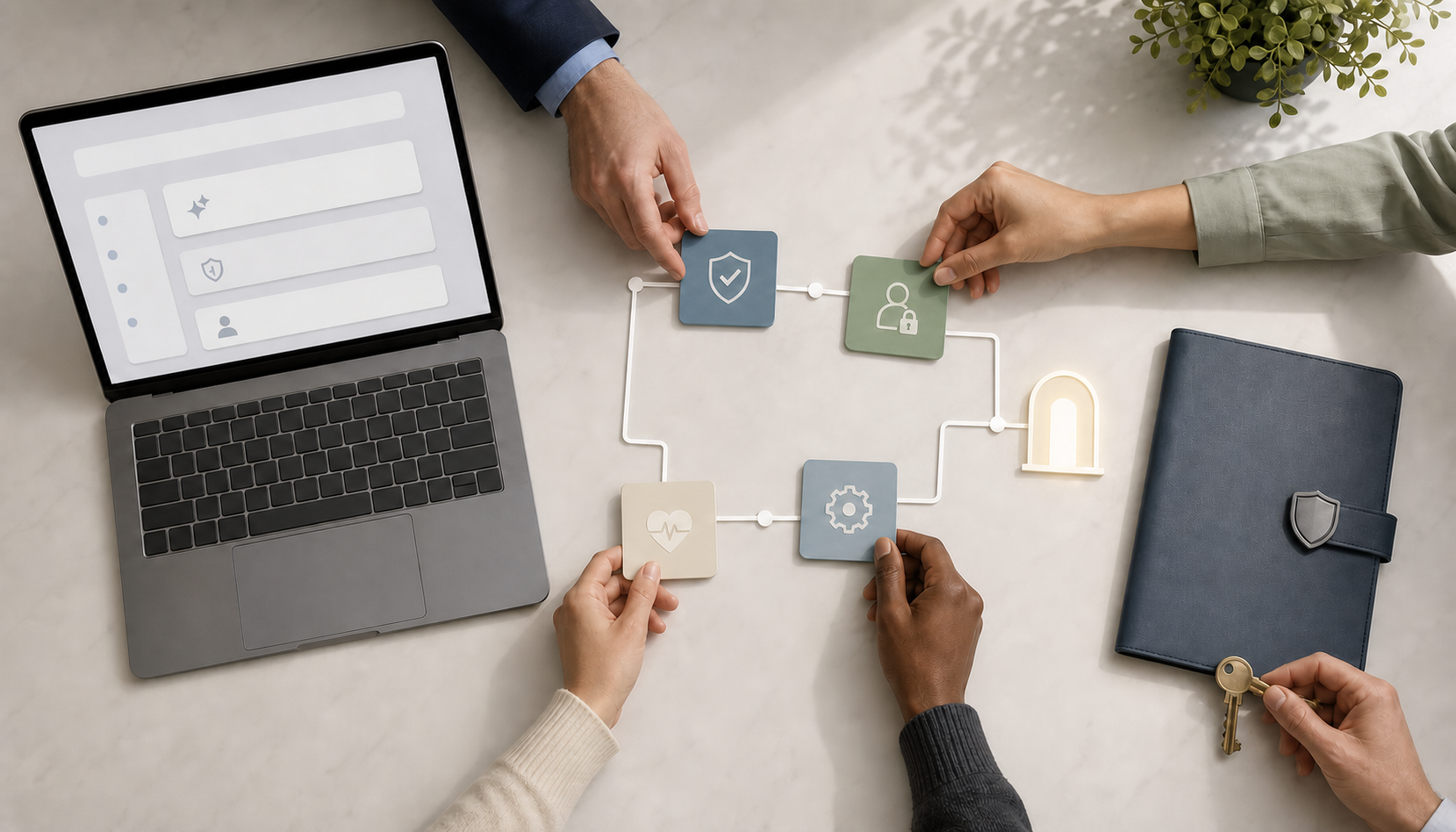 Hands arrange unlabeled planning tiles beside a laptop and a secured records folder with a key on a conference table.