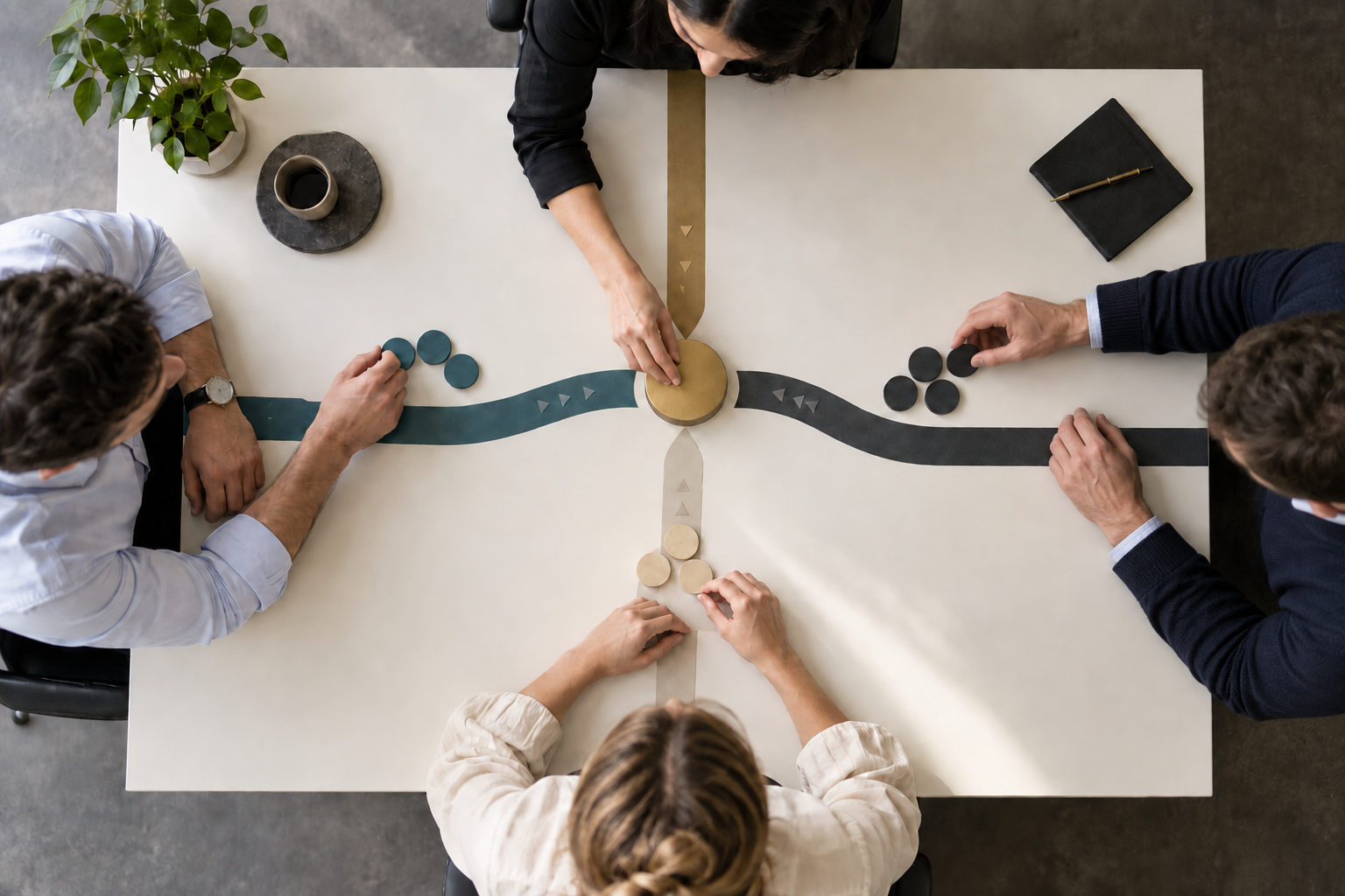 Four colleagues organize color-coded decision tokens around converging project paths while one person moves the central token forward.
